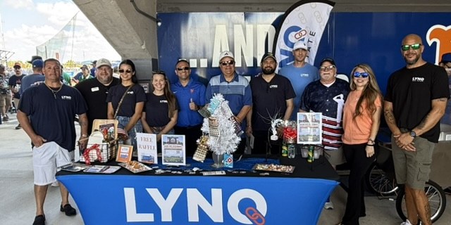 LYNQ agents at the LYNQ marketing table at a St. Lucie Mets game